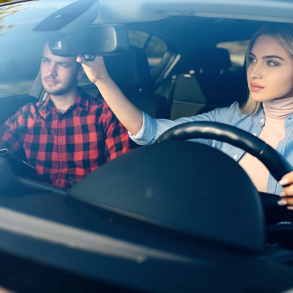 lady-and-male-instructor-in-car-driving-school-GAH3GZ6.jpg